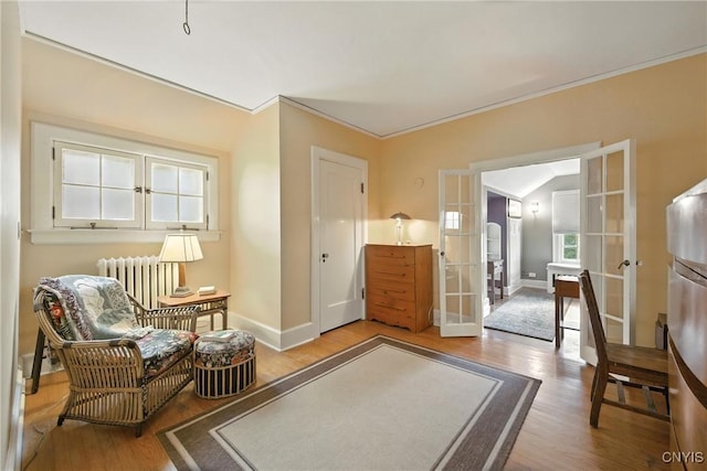 306 Berkeley Dr, Syracuse, NY 13210 - living area with french doors, radiator heating unit, wood finished floors, and ornamental molding