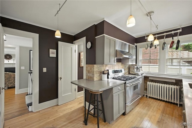 306 Berkeley Dr, Syracuse, NY 13210 - kitchen featuring gas stove, radiator, light wood-style flooring, backsplash, and decorative light fixtures