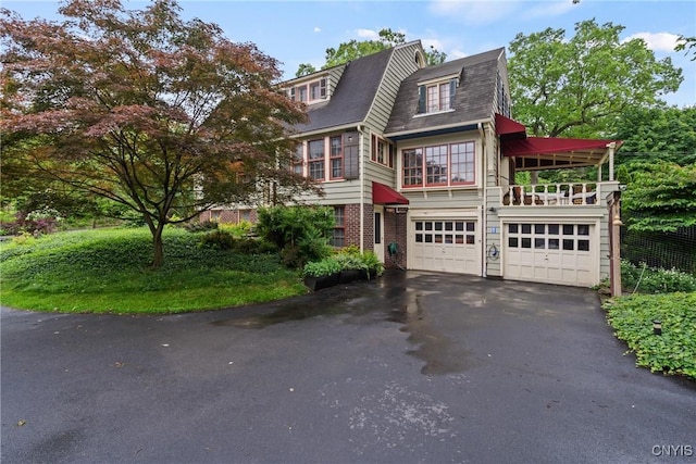 306 Berkeley Dr, Syracuse, NY 13210 - view of front facade with driveway and a garage