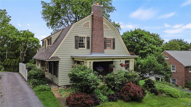 306 Berkeley Dr, Syracuse, NY 13210 - colonial inspired home featuring a chimney and a gambrel roof