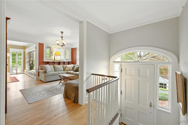 306 Berkeley Dr, Syracuse, NY 13210 - entrance foyer featuring a chandelier, healthy amount of natural light, light wood-type flooring, and crown molding