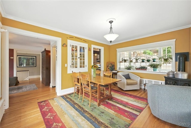 306 Berkeley Dr, Syracuse, NY 13210 - dining room featuring light wood-type flooring, crown molding, and a wood stove