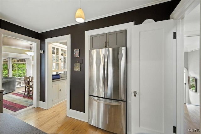 306 Berkeley Dr, Syracuse, NY 13210 - kitchen with freestanding refrigerator, light wood finished floors, crown molding, and decorative light fixtures