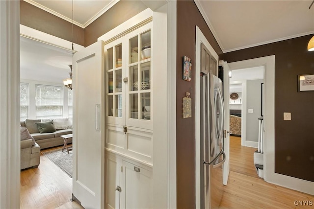 306 Berkeley Dr, Syracuse, NY 13210 - corridor featuring light wood-style flooring, ornamental molding, and a chandelier