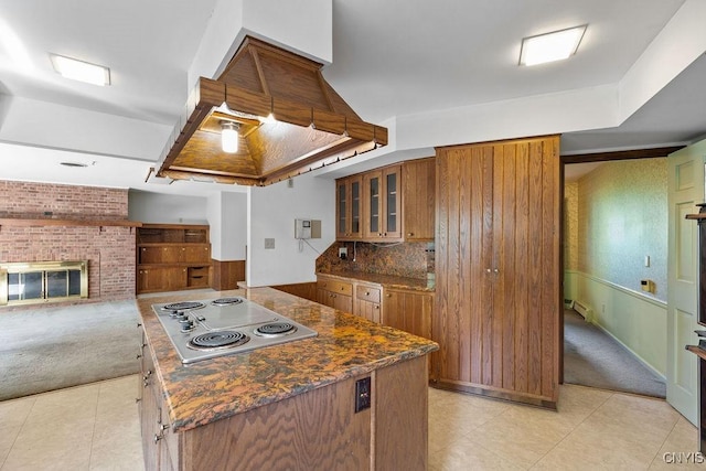 20 Cross Rd, Dewitt, NY 13224 - kitchen with stainless steel electric stovetop, brown cabinetry, light colored carpet, and glass insert cabinets
