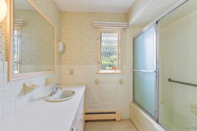 20 Cross Rd, Dewitt, NY 13224 - full bathroom featuring baseboard heating, wallpapered walls, vanity, wainscoting, and bath / shower combo with glass door