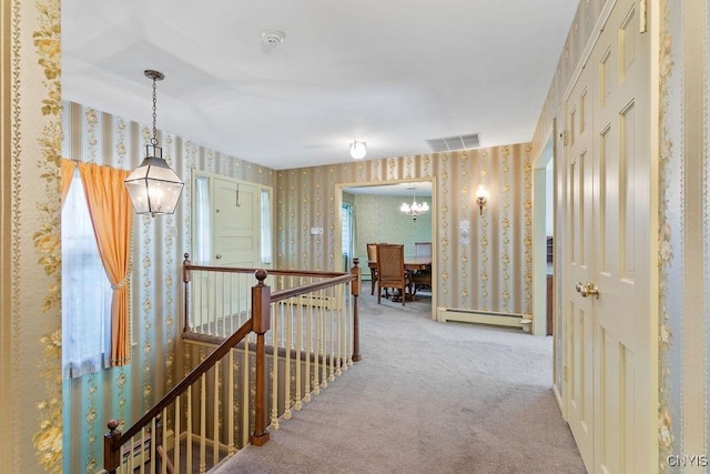 20 Cross Rd, Dewitt, NY 13224 - hallway with wallpapered walls, an upstairs landing, carpet floors, a baseboard radiator, and a chandelier