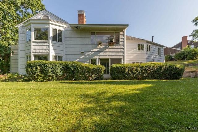 20 Cross Rd, Dewitt, NY 13224 - rear view of property with a yard and a chimney