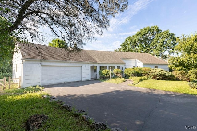 20 Cross Rd, Dewitt, NY 13224 - single story home with asphalt driveway, an attached garage, and a shingled roof