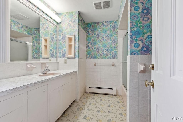 20 Cross Rd, Dewitt, NY 13224 - full bath with a baseboard heating unit, wallpapered walls, tile walls, vanity, and a wainscoted wall