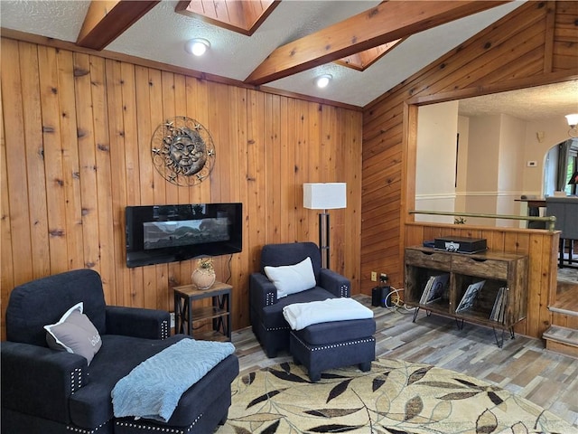 211 Steko Ave, Rochester, NY 14615 - living room with wood finished floors, a skylight, arched walkways, and wood walls