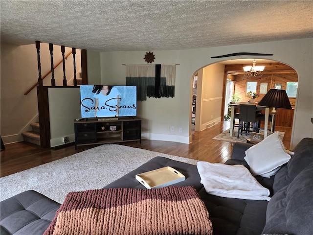 211 Steko Ave, Rochester, NY 14615 - living area featuring arched walkways, a chandelier, wood finished floors, a textured ceiling, and stairway