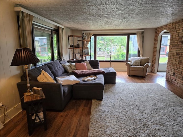 211 Steko Ave, Rochester, NY 14615 - living area featuring hardwood / wood-style flooring, a textured ceiling, and arched walkways