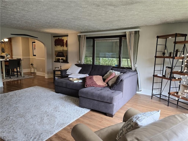 211 Steko Ave, Rochester, NY 14615 - living area with arched walkways, wood finished floors, and a textured ceiling