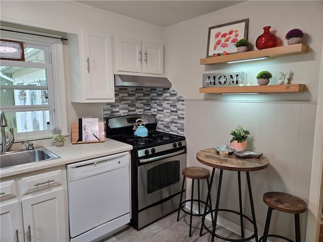 211 Steko Ave, Rochester, NY 14615 - kitchen with white dishwasher, stainless steel gas range oven, under cabinet range hood, white cabinets, and healthy amount of natural light