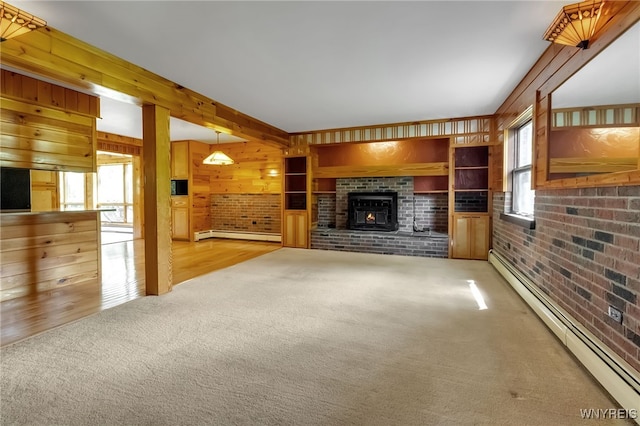 1520 Davis Rd, Aurora, NY 14170 - unfurnished living room featuring baseboard heating, light colored carpet, brick wall, a brick fireplace, and wood walls