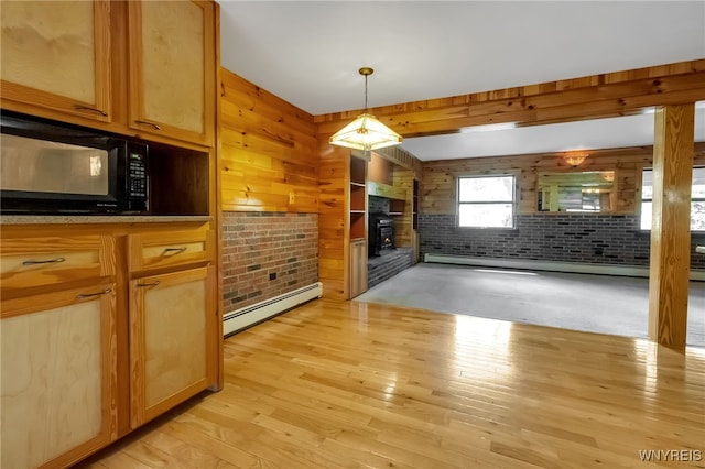 1520 Davis Rd, Aurora, NY 14170 - unfurnished living room with baseboard heating, light wood-type flooring, a fireplace, and wooden walls