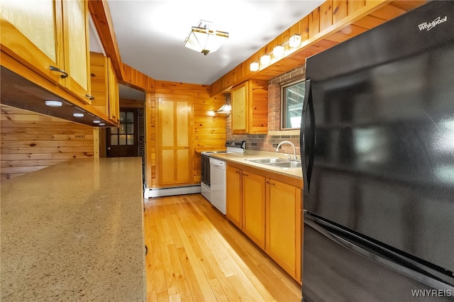 1520 Davis Rd, Aurora, NY 14170 - kitchen featuring freestanding refrigerator, white dishwasher, a baseboard heating unit, light countertops, and wood walls