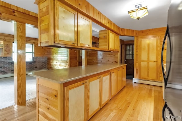 1520 Davis Rd, Aurora, NY 14170 - kitchen with refrigerator, a baseboard radiator, light wood-type flooring, light brown cabinetry, and light countertops