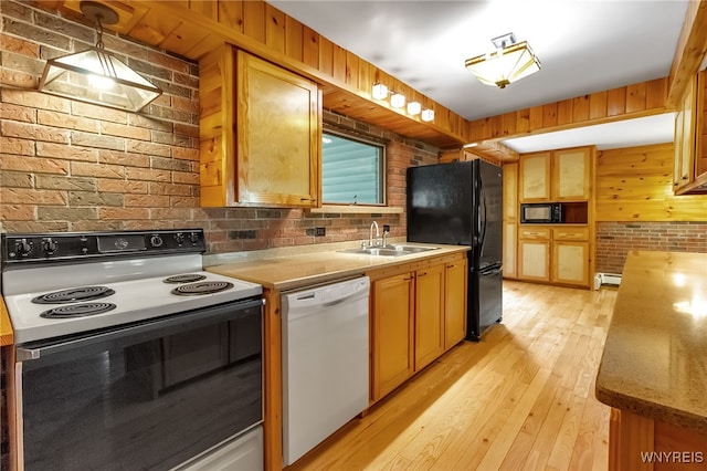 1520 Davis Rd, Aurora, NY 14170 - kitchen with black appliances, light wood-type flooring, brick wall, a baseboard heating unit, and light stone counters