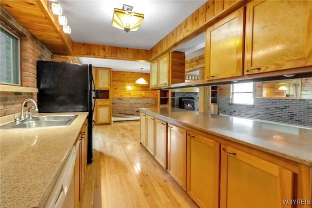 1520 Davis Rd, Aurora, NY 14170 - kitchen with light wood-style flooring, white dishwasher, a baseboard heating unit, a lit fireplace, and backsplash