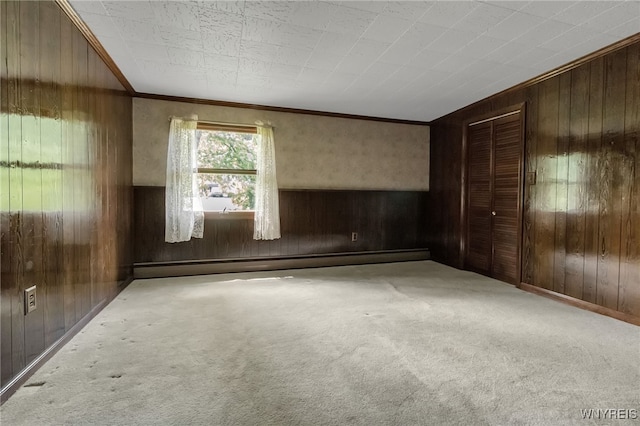 1520 Davis Rd, Aurora, NY 14170 - unfurnished bedroom featuring wood walls, a baseboard radiator, crown molding, carpet floors, and a closet