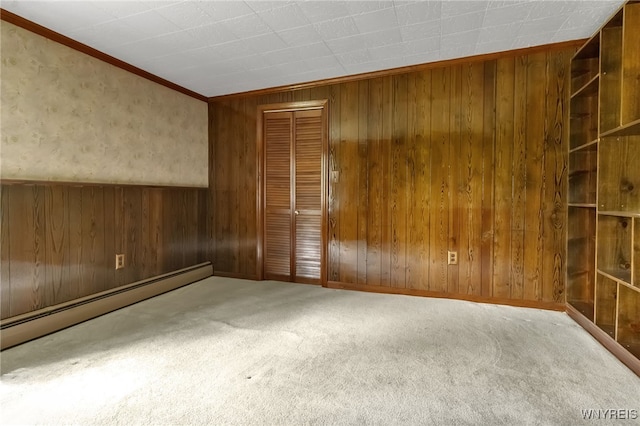1520 Davis Rd, Aurora, NY 14170 - carpeted empty room with wooden walls, a baseboard heating unit, and ornamental molding