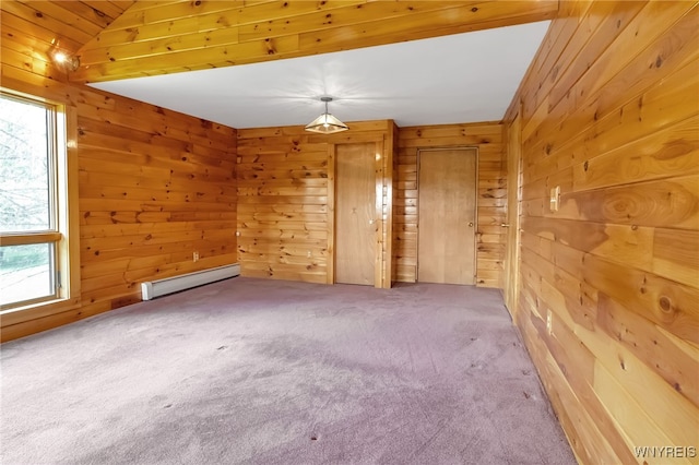 1520 Davis Rd, Aurora, NY 14170 - empty room featuring a baseboard heating unit, wood walls, and carpet floors