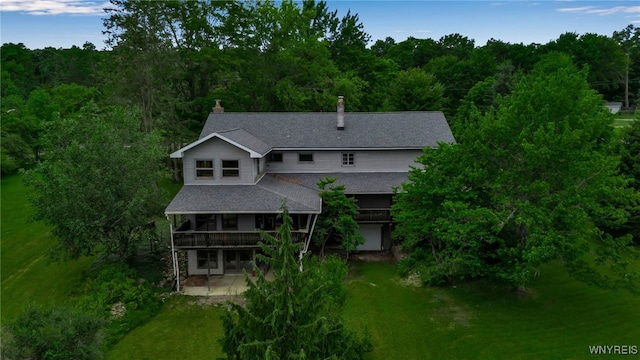 1520 Davis Rd, Aurora, NY 14170 - back of property featuring a patio, a lawn, a deck, roof with shingles, and a view of trees