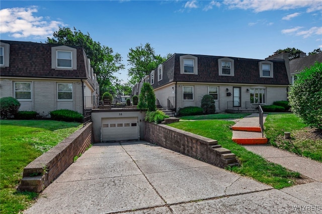 32 Bernhardt Dr Unit 5, Amherst, NY 14226 - front facade with mansard roof, roof with shingles, concrete driveway, a garage, and a front yard