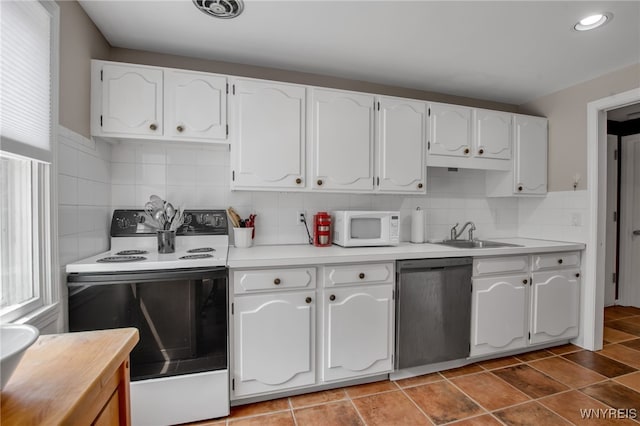 32 Bernhardt Dr Unit 5, Amherst, NY 14226 - kitchen featuring white appliances, white cabinets, light countertops, backsplash, and recessed lighting