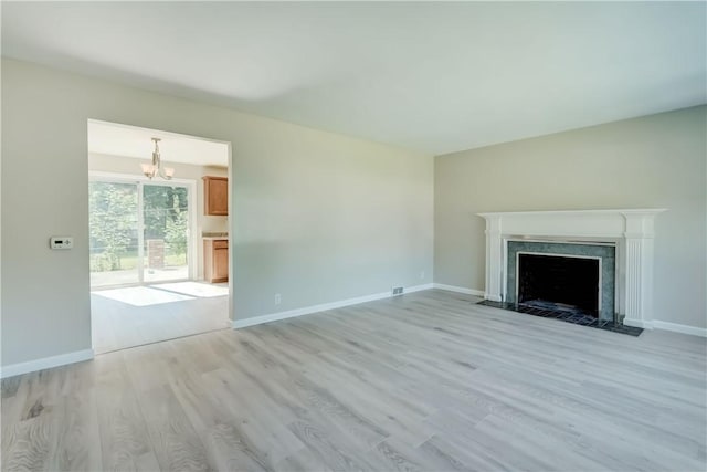 3245 Culver Rd, Irondequoit, NY 14622 - unfurnished living room with a chandelier, light wood finished floors, and a high end fireplace