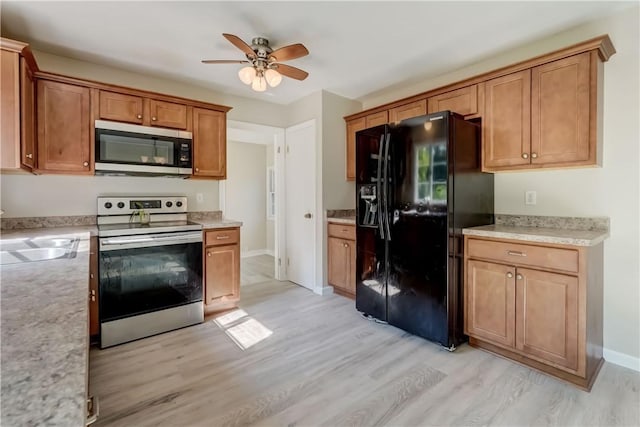 3245 Culver Rd, Irondequoit, NY 14622 - kitchen featuring appliances with stainless steel finishes, light wood-style flooring, ceiling fan, and light countertops