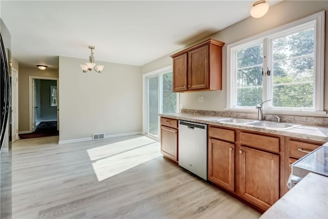 3245 Culver Rd, Irondequoit, NY 14622 - kitchen featuring dishwasher, brown cabinets, a chandelier, light wood-style flooring, and light countertops