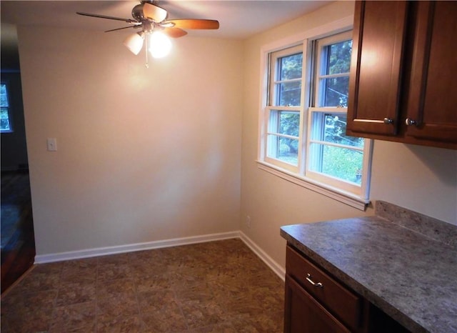 3245 Culver Rd, Irondequoit, NY 14622 - unfurnished dining area with baseboards and ceiling fan