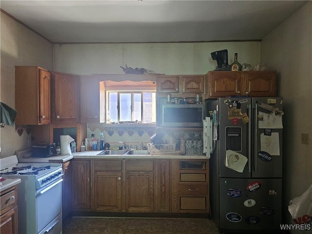 209 W Ferry St Unit S, Buffalo, NY 14213 - kitchen featuring white gas range oven, refrigerator with ice dispenser, light countertops, and brown cabinetry
