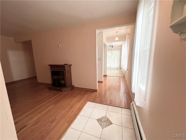23 Burden Dr, Oswego, NY 13126 - corridor featuring a baseboard heating unit and wood finished floors