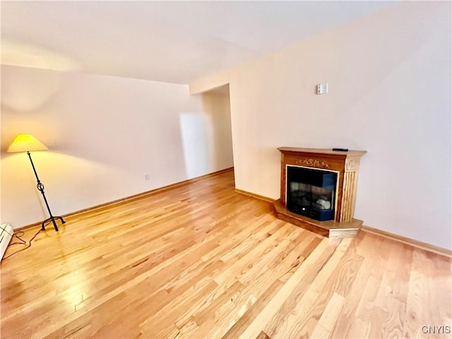 23 Burden Dr, Oswego, NY 13126 - unfurnished living room featuring wood finished floors and a glass covered fireplace