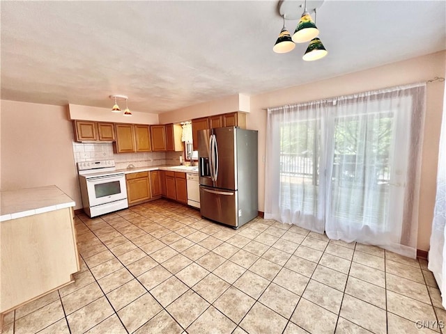 23 Burden Dr, Oswego, NY 13126 - kitchen with white appliances, light tile patterned flooring, tasteful backsplash, and tile countertops