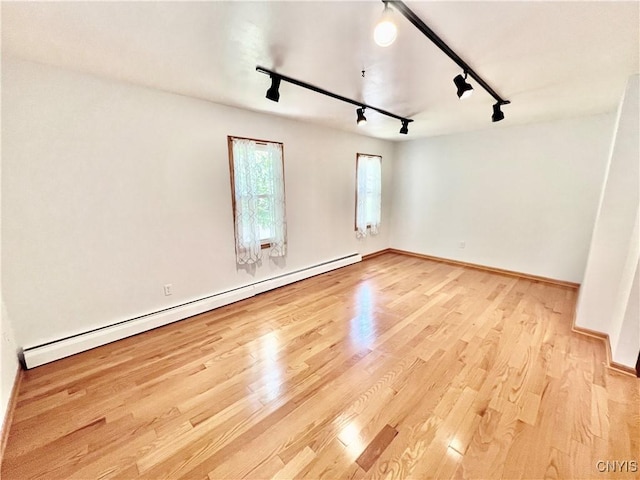 23 Burden Dr, Oswego, NY 13126 - empty room with baseboard heating, track lighting, and light wood finished floors