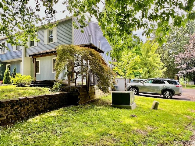 23 Burden Dr, Oswego, NY 13126 - view of side of home featuring a lawn