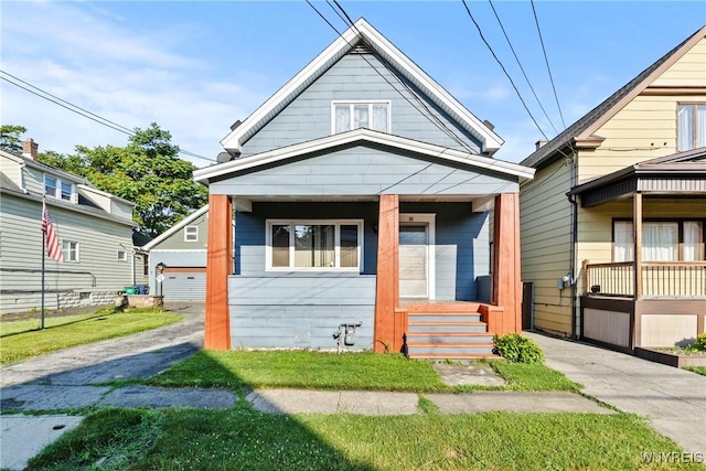 84 Pulaski St, Buffalo, NY 14206 - shotgun-style home with covered porch and an outbuilding