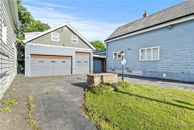 84 Pulaski St, Buffalo, NY 14206 - view of property exterior featuring an outbuilding, a detached garage, and a lawn