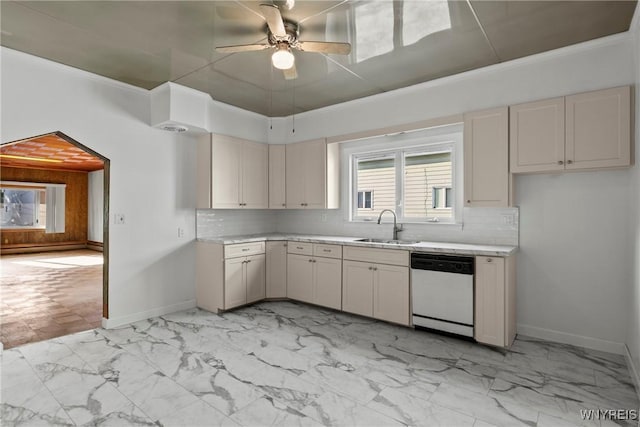 84 Pulaski St, Buffalo, NY 14206 - kitchen featuring white dishwasher, light countertops, ceiling fan, decorative backsplash, and light marble finish floors