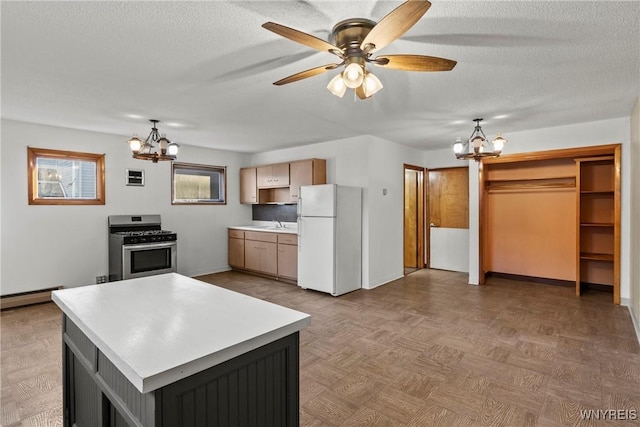 84 Pulaski St, Buffalo, NY 14206 - kitchen featuring freestanding refrigerator, a chandelier, stainless steel gas stove, light countertops, and a textured ceiling