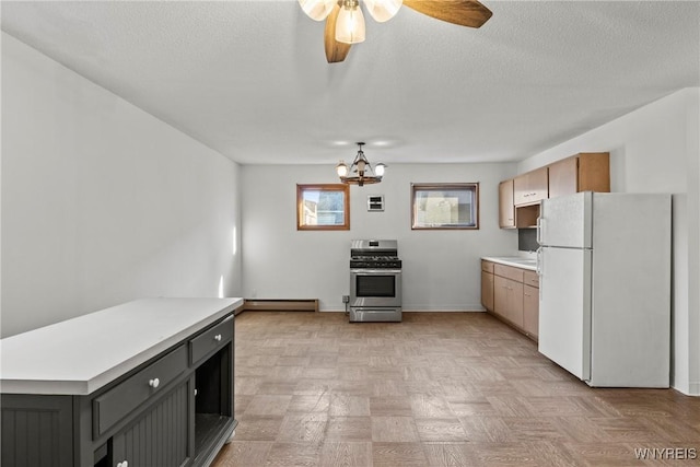 84 Pulaski St, Buffalo, NY 14206 - kitchen featuring freestanding refrigerator, stainless steel range with gas stovetop, a baseboard radiator, light countertops, and a ceiling fan