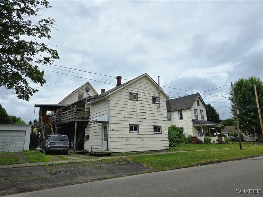 1019 Spruce St Unit 1, Olean, NY 14760 - view of side of home with a yard, driveway, and a garage