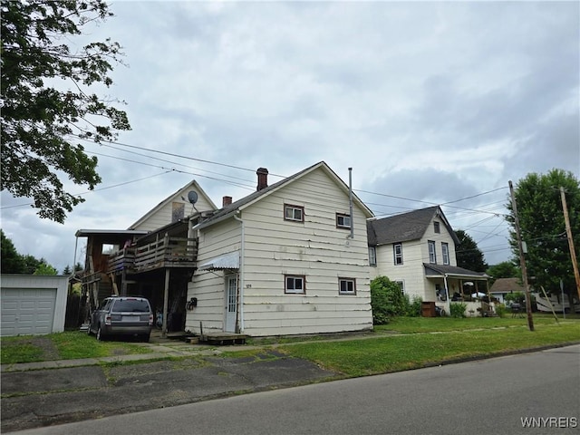 1019 Spruce St Unit 1, Olean, NY 14760 - view of side of home with a yard, driveway, and a garage