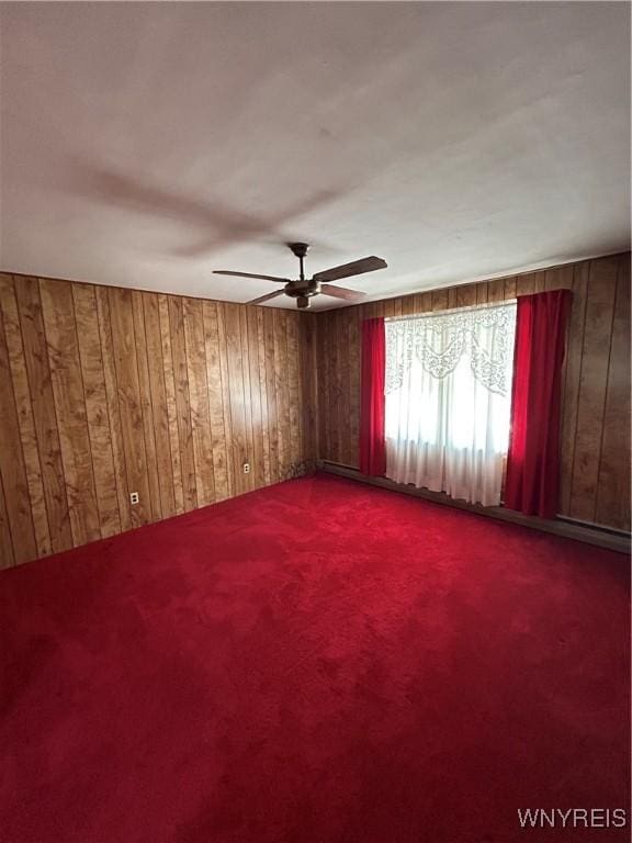 83 Felton St, North Tonawanda, NY 14120 - carpeted empty room featuring wood walls and a ceiling fan