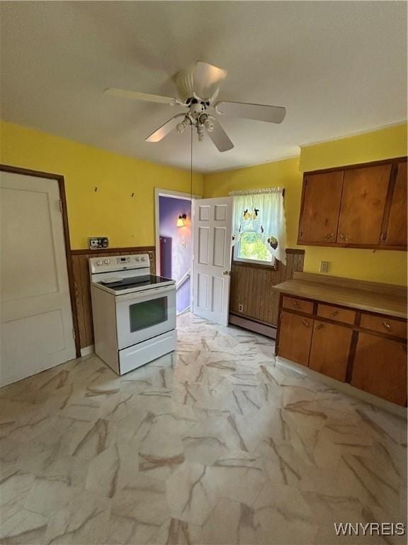 83 Felton St, North Tonawanda, NY 14120 - kitchen featuring white range with electric cooktop, baseboard heating, brown cabinets, ceiling fan, and light marble finish floors